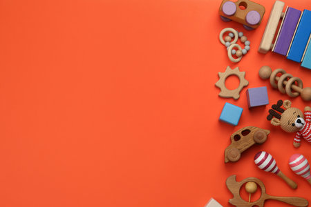 Different children's toys on orange background, flat lay. Space for textの写真素材