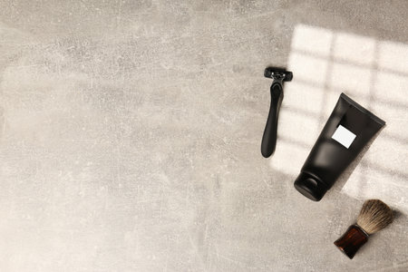 Set of men's shaving tools on light gray textured table, flat lay. Space for textの写真素材