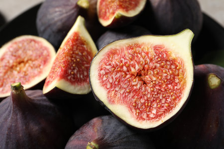 Whole and cut ripe figs on blurred background, closeupの写真素材