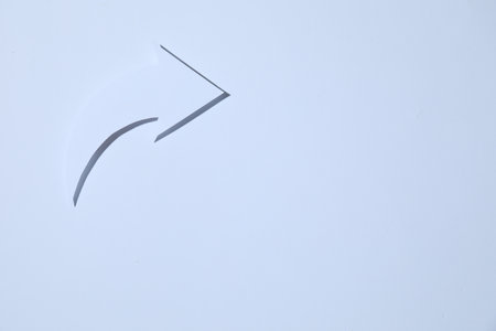 Curved paper arrow on white background, top view. Space for textの写真素材