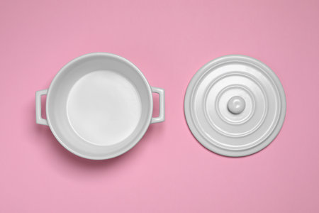 White pot and lid on pink background, flat layの写真素材