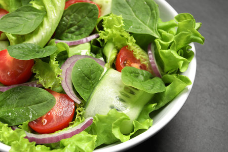 Delicious vegetable salad on gray table, closeupの写真素材