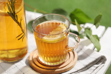 Glass cup of tasty iced tea with lemon on table, closeupの写真素材