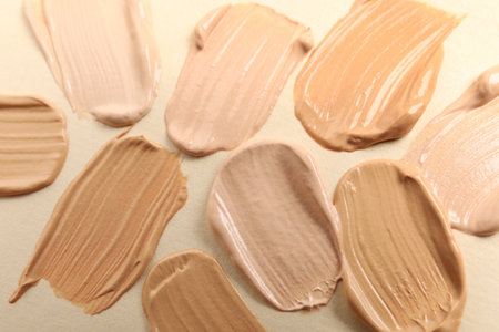Samples of skin foundation on beige background, closeupの写真素材