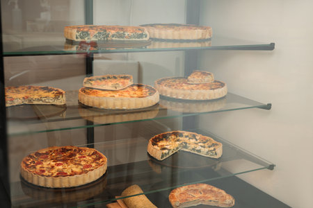 Different delicious quiches on counter in storeの写真素材