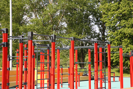 Empty outdoor gym with exercise equipment in park