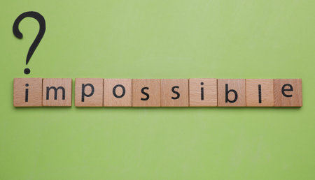 Motivation concept. Word Impossible and question mark on light green background, flat lay
