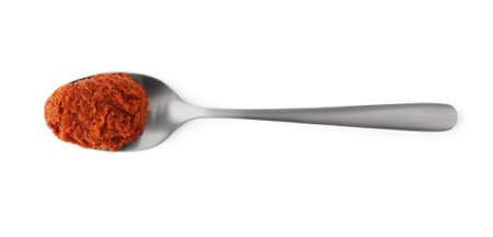 Tasty curry paste in spoon isolated on white, top viewの写真素材