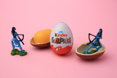 Sveti Vlas, Bulgaria - June 30, 2023: Kinder Surprise Eggs, plastic capsule and toys on pink...