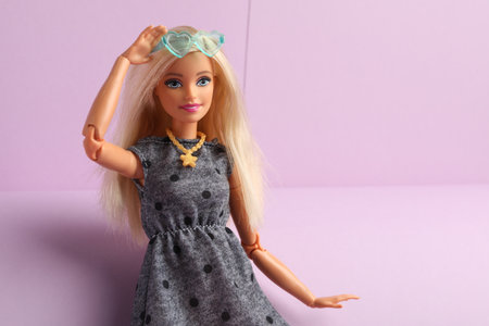Mykolaiv, Ukraine - September 4, 2023: Beautiful Barbie doll with stylish eyeglasses on lilac background, space for textのeditorial素材