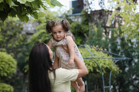 Mother with her cute daughter spending time together in parkの写真素材