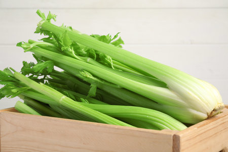 Wooden box with fresh celery bunches, closeupの写真素材