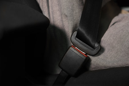 Fastened safety seat belt in car, closeup