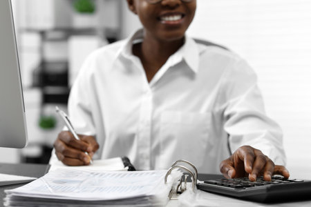 Professional accountant working at desk in office, closeupの写真素材