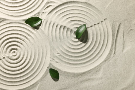 Beautiful spirals and leaves on sand, top view. Zen gardenの写真素材