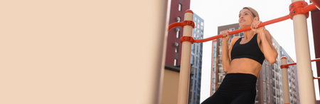 Happy woman doing pull-ups at outdoor gym, space for text. Banner design