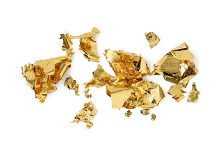Many pieces of edible gold leaf isolated on white, top viewの写真素材
