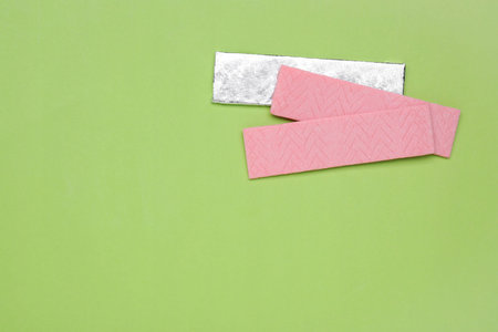 Sticks of tasty chewing gum on light green background, flat lay. Space for textの写真素材