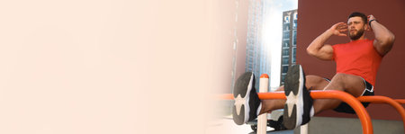 Handsome man doing abs exercise on parallel bars at outdoor gym, space for text. Banner design