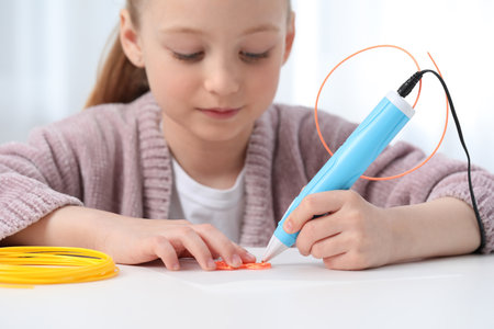 Girl drawing with stylish 3D pen at white table indoors, selective focus
