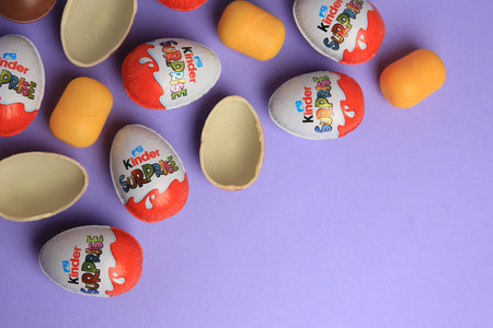 Sveti Vlas, Bulgaria - June 29, 2023: Kinder Surprise Eggs and plastic capsules on violet...