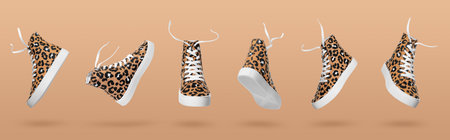 Stylish sneaker in air on beige background, view from different sidesの写真素材