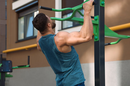 Man doing pull ups at outdoor gym