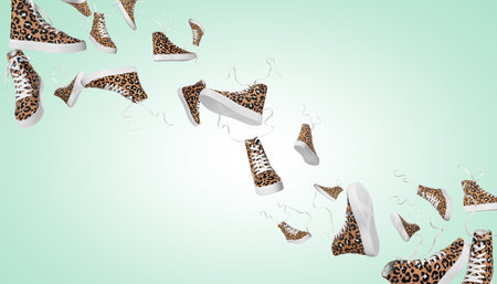 Stylish sneakers in air on turquoise backgroundの写真素材