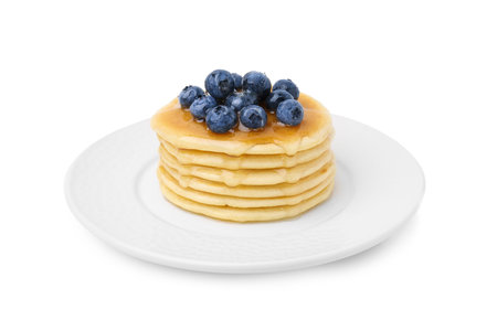 Delicious pancakes with blueberries and honey isolated on whiteの写真素材