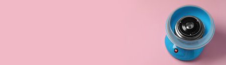 Portable candy cotton machine on pink background. Banner design with space for textの写真素材
