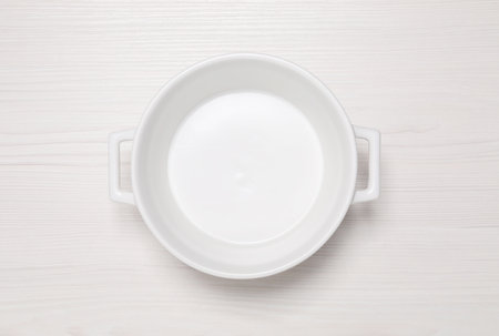 Empty pot on white wooden table, top viewの写真素材