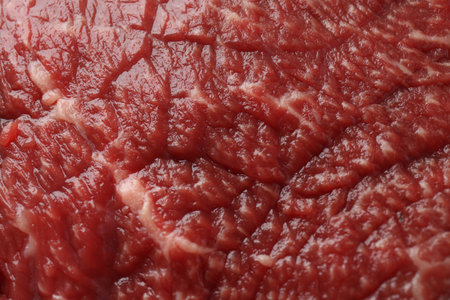 Texture of fresh beef meat as background, closeup