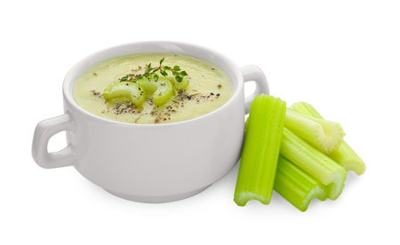 Bowl of delicious celery soup and fresh stalks on white backgroundの写真素材