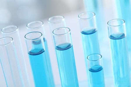 Test tubes with light blue liquid in laboratory, closeupの写真素材