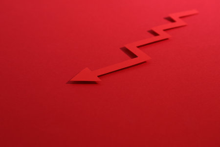 One zigzag paper arrow on red background, closeup. Space for textの写真素材
