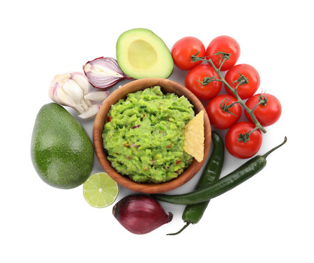 Delicious guacamole with nachos chips and ingredients isolated on white, top viewの写真素材