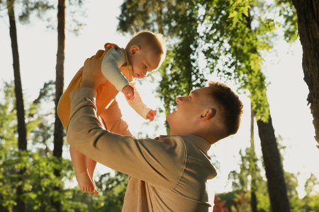 Father with his cute daughter spending time together in park on summer dayの写真素材