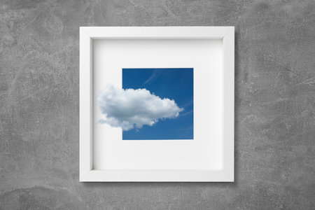 Clouds floating outside of picture with beautiful sky on gray textured backgroundの写真素材