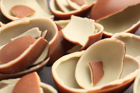 Sveti Vlas, Bulgaria - July 3, 2023: Broken halves of Kinder Surprise Eggs on gray background, closeupのeditorial素材