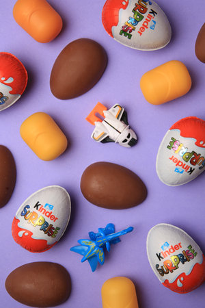 Sveti Vlas, Bulgaria - June 30, 2023: Kinder Surprise Eggs, toys and plastic capsules on violet...