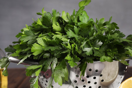 Colander with fresh parsley on table, closeupの写真素材