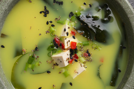 Bowl of delicious miso soup with tofu, top viewの写真素材