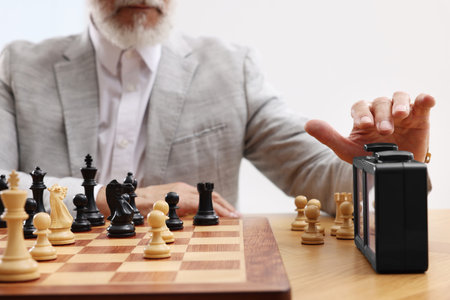 Man turning on chess clock during tournament at table, closeupの写真素材