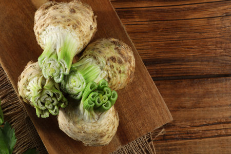 Fresh raw celery roots on wooden table, top view. Space for textの写真素材