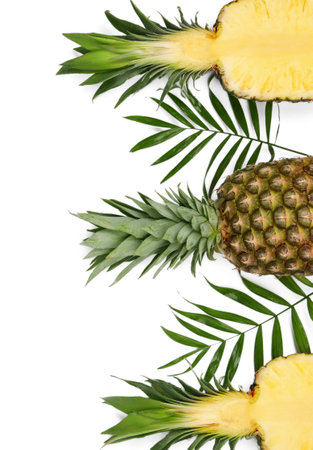 Whole and cut ripe pineapples on white background, flat lay. Space for textの写真素材