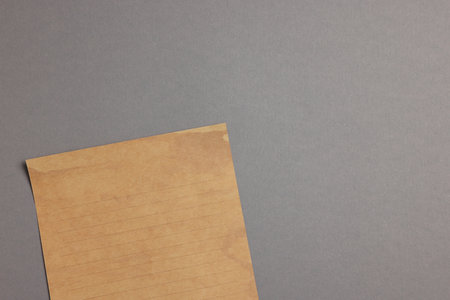 Sheet of old parchment paper on gray background, top view. Space for textの写真素材