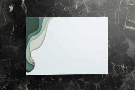 Blank invitation card on black marble background, top view. Space for text