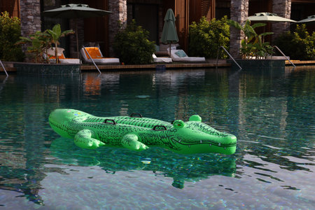 Float in shape of crocodile in swimming pool at luxury resortの写真素材