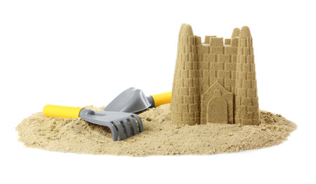 Pile of sand with beautiful castle and plastic toys isolated on whiteの写真素材