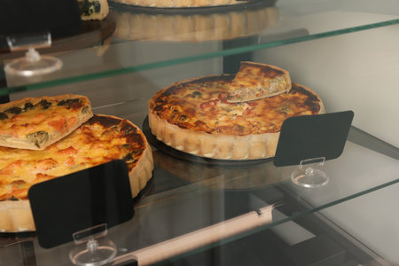 Different delicious quiches on counter in storeの写真素材